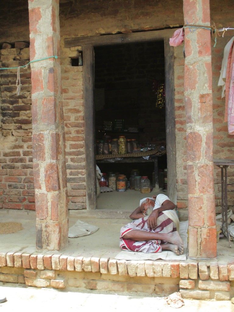 A villager sleeping outside his shop